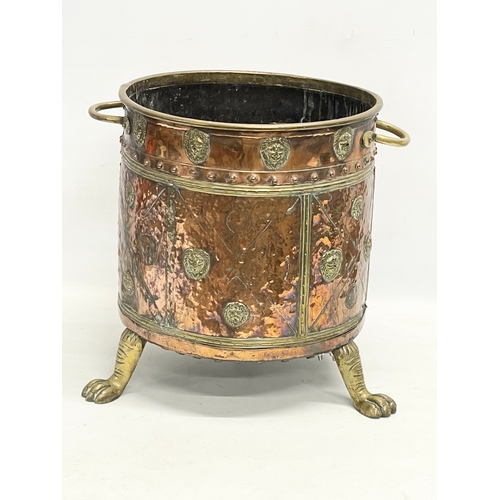 35 - A large Victorian copper and brass coal coal bucket on brass lion paw feet and lion head mouldings. ... 