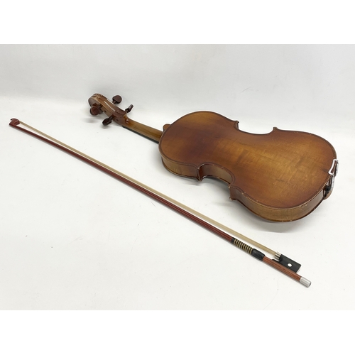 298M - A vintage violin in case. Violin measures 61cm