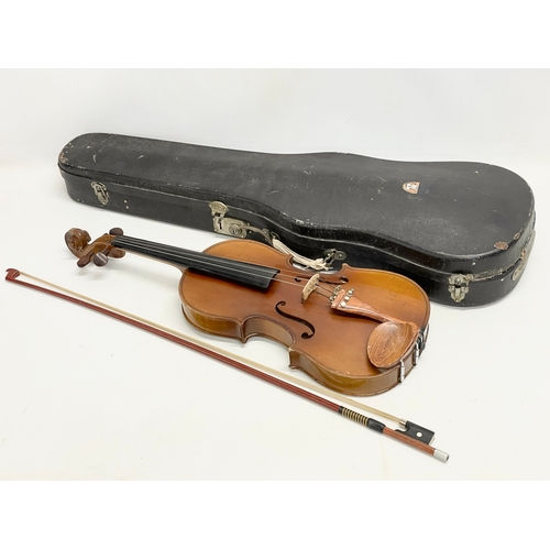 298M - A vintage violin in case. Violin measures 61cm