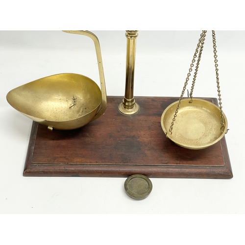 219C - A late Victorian brass and oak balance scales. 41x22x49cm