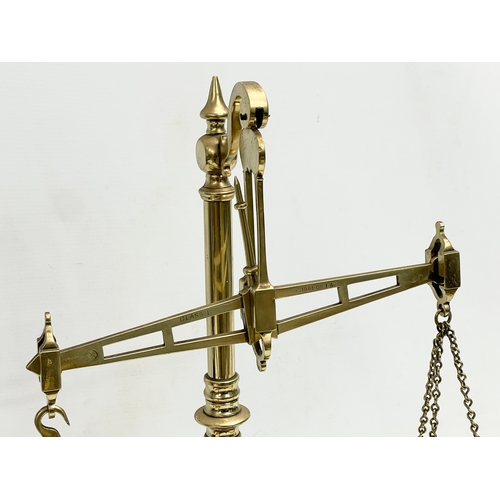 219C - A late Victorian brass and oak balance scales. 41x22x49cm