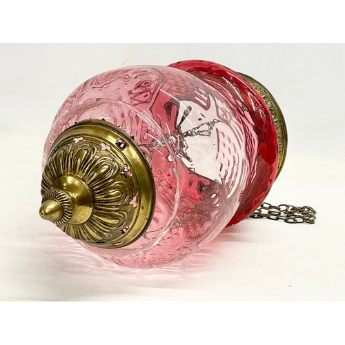 272K - An early 20th century brass and Ruby Glass light shade. Circa 1900. Shade measures 21x34cm. 62cm inc... 