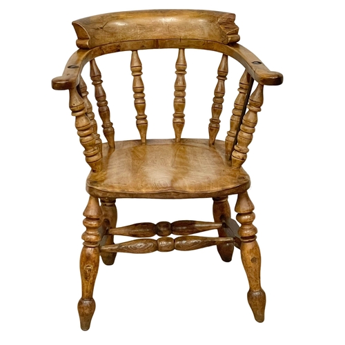 1128 - A Victorian Elm and Beech smokers armchair.