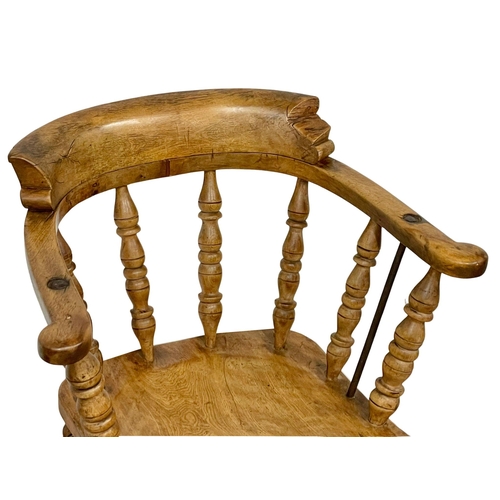 1128 - A Victorian Elm and Beech smokers armchair.