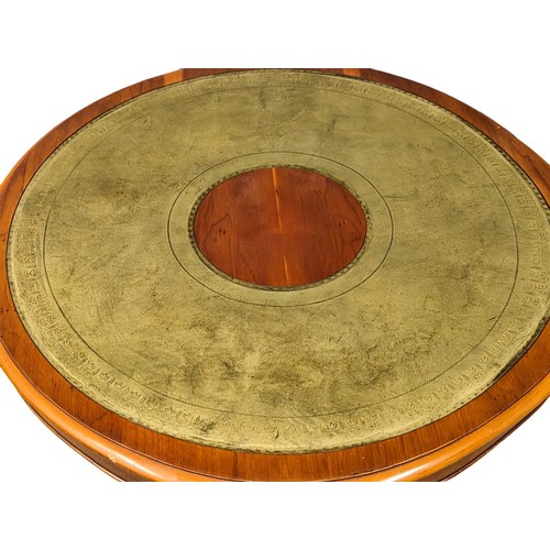 1130 - A Georgian style yew wood drum coffee table with leather top and pedestal base. 90x53cm