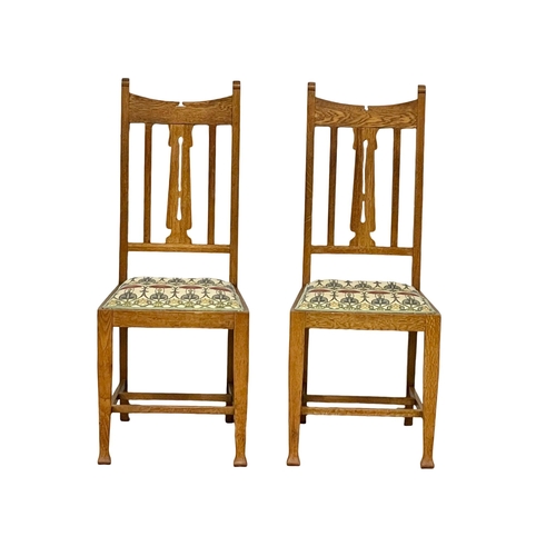 1131 - A pair of early 20th century Arts & Crafts oak high back side chairs.