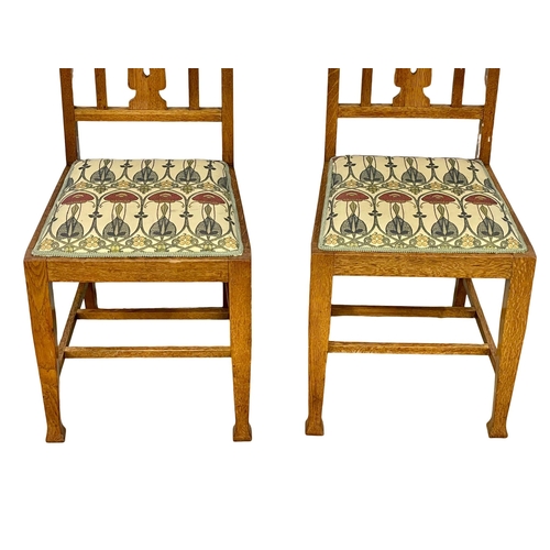 1131 - A pair of early 20th century Arts & Crafts oak high back side chairs.