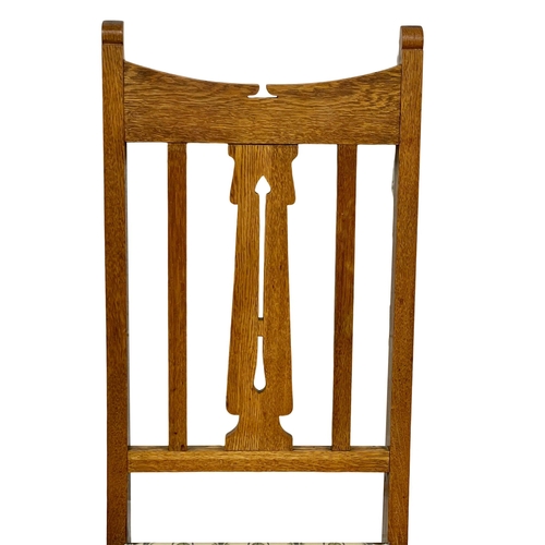 1131 - A pair of early 20th century Arts & Crafts oak high back side chairs.