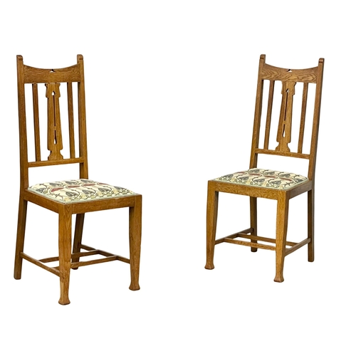 1131 - A pair of early 20th century Arts & Crafts oak high back side chairs.