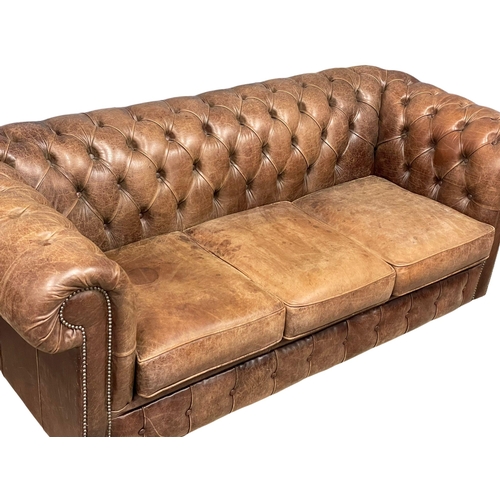 1001 - A deep button leather chesterfield 3 seater sofa.