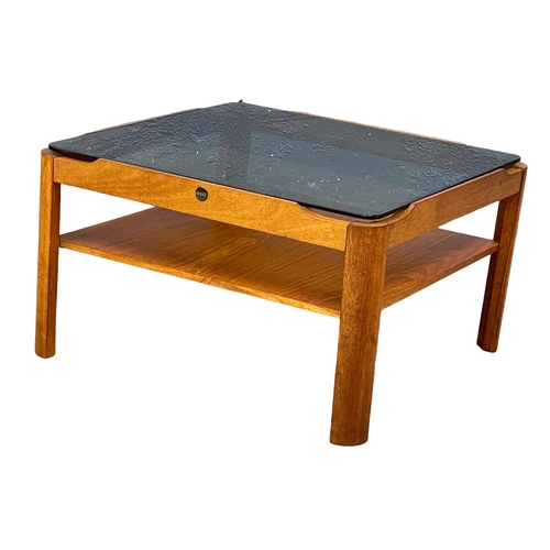 1141 - A Mid Century teak coffee table with smoked glass top by Myer. 61x61x35xm