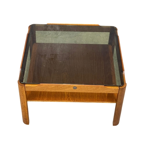 1141 - A Mid Century teak coffee table with smoked glass top by Myer. 61x61x35xm