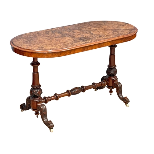 875 - A Victorian Burr Walnut library table with carved cabriole legs and stretcher support. 122x60x72cm