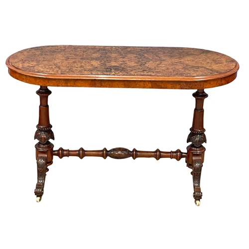 875 - A Victorian Burr Walnut library table with carved cabriole legs and stretcher support. 122x60x72cm