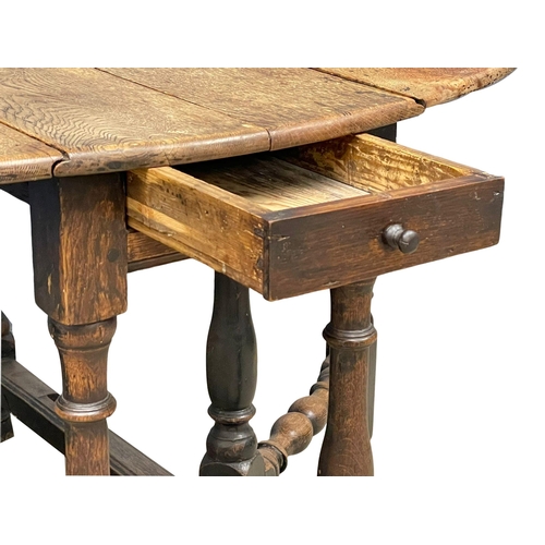 887 - A George I early 18th century oak drop leaf gateleg table with drawer. Circa 1720. Open 126x98x68cm.... 