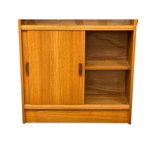 889 - A Mid Century teak bookcase. 83x28x136cm