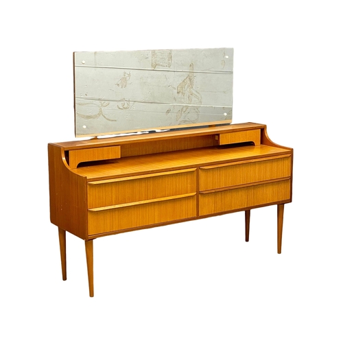 890 - A 1960’s Mid Century teak dressing table. 128.5x40x115.5cm