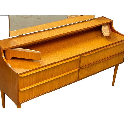 890 - A 1960’s Mid Century teak dressing table. 128.5x40x115.5cm