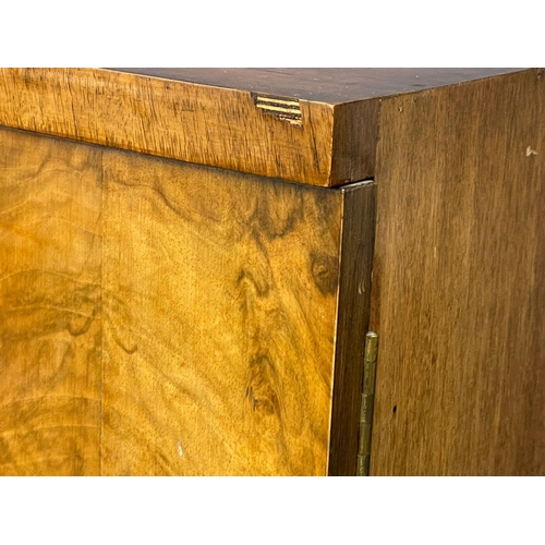 892 - An Art Deco walnut tallboy cabinet with fitted shelves. 84x48.5x118cm