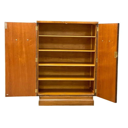 892 - An Art Deco walnut tallboy cabinet with fitted shelves. 84x48.5x118cm