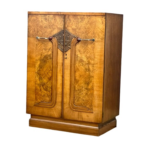 892 - An Art Deco walnut tallboy cabinet with fitted shelves. 84x48.5x118cm