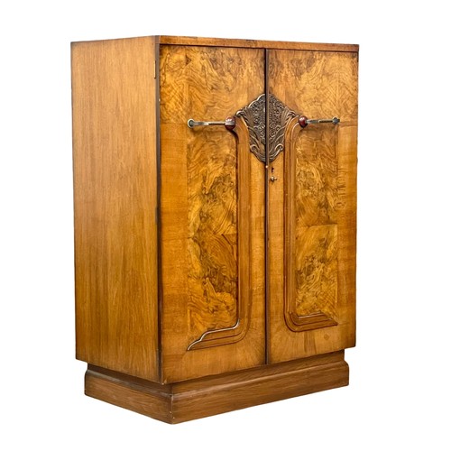 892 - An Art Deco walnut tallboy cabinet with fitted shelves. 84x48.5x118cm