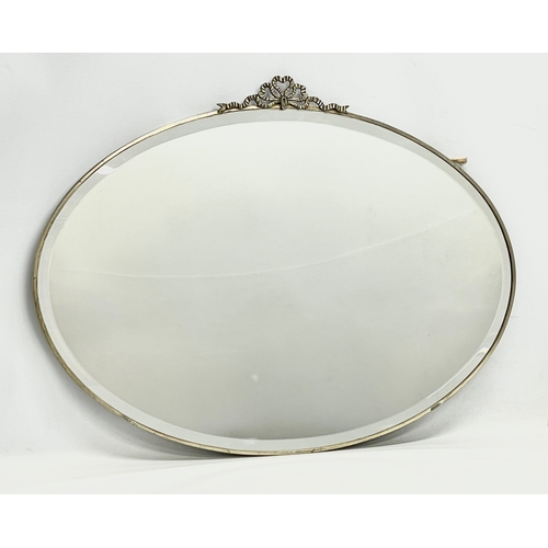 720 - An early 20th century brass framed bevelled mirror. 1900-1920. 76x56cm