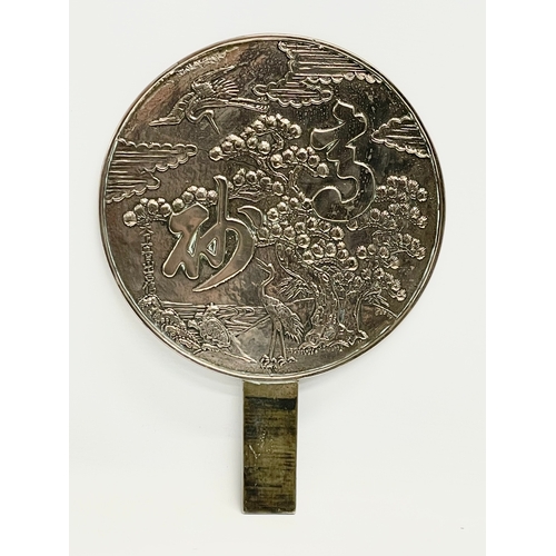 4 - A late 19th century Japanese bronze hand mirror. Decorated with cranes and tree. 23x32cm