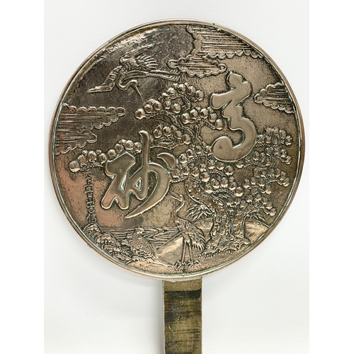 4 - A late 19th century Japanese bronze hand mirror. Decorated with cranes and tree. 23x32cm