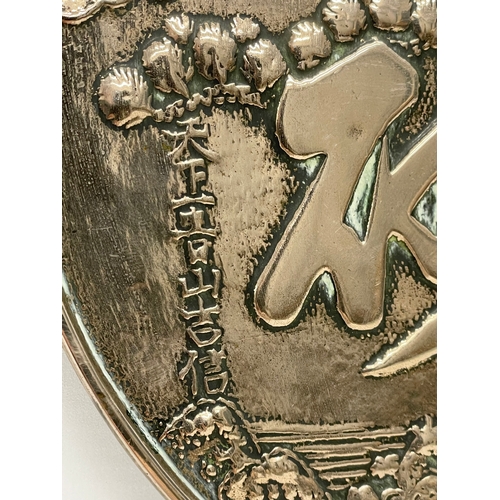 4 - A late 19th century Japanese bronze hand mirror. Decorated with cranes and tree. 23x32cm