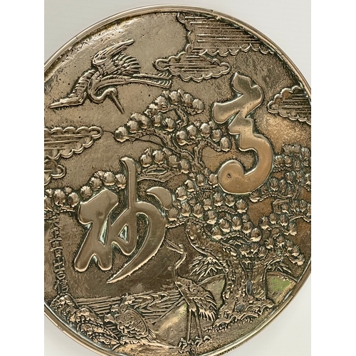 4 - A late 19th century Japanese bronze hand mirror. Decorated with cranes and tree. 23x32cm