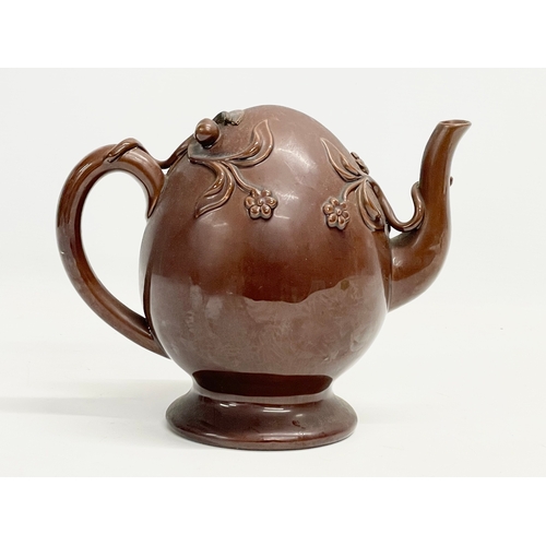 46 - A late 19th century Copeland Treacle Glazed Cadogan pottery teapot. 24x13x19.5cm