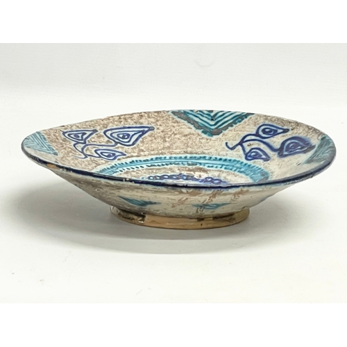 298 - An early to mid 20th century Middle Eastern hand painted terracotta bowl. 26cm