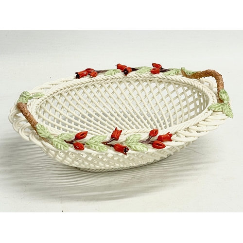 66 - A Belleek Pottery ‘Fuchia Basket’ with box. 20x16x7cm