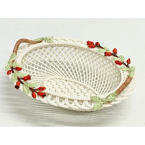 66 - A Belleek Pottery ‘Fuchia Basket’ with box. 20x16x7cm