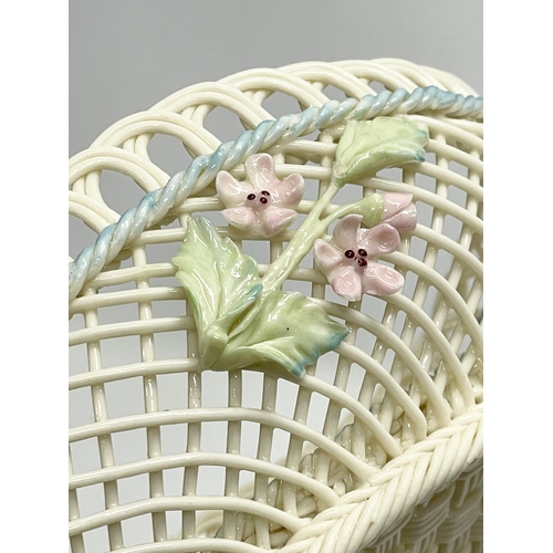 67 - A Belleek Pottery woven basket. 18.5x13.5x6.5cm