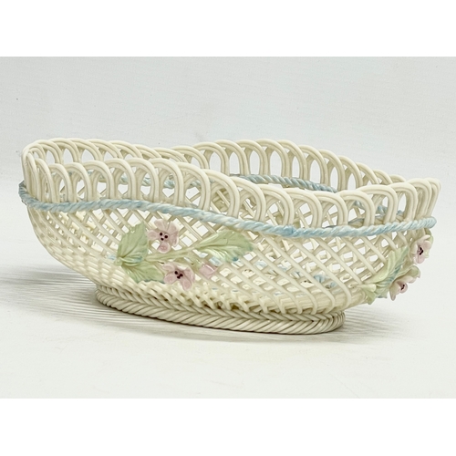 67 - A Belleek Pottery woven basket. 18.5x13.5x6.5cm