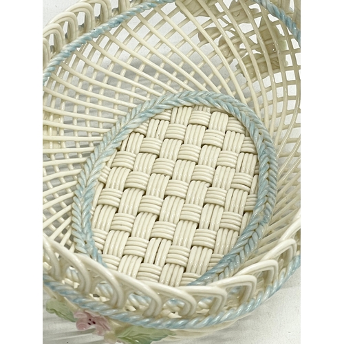 67 - A Belleek Pottery woven basket. 18.5x13.5x6.5cm