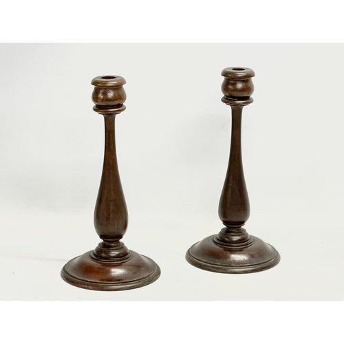 80 - A pair of early 20th century oak candlesticks. Circa 1920. 15x30.5cm