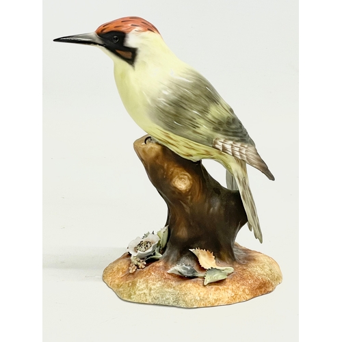 258 - A Royal Crown Derby “Green Woodpecker” figurine. 15cm