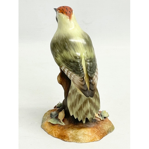 258 - A Royal Crown Derby “Green Woodpecker” figurine. 15cm