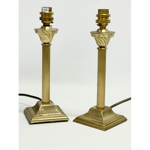 83 - A pair of Christopher Wray brass table lamps. Bases measure 26.5cm