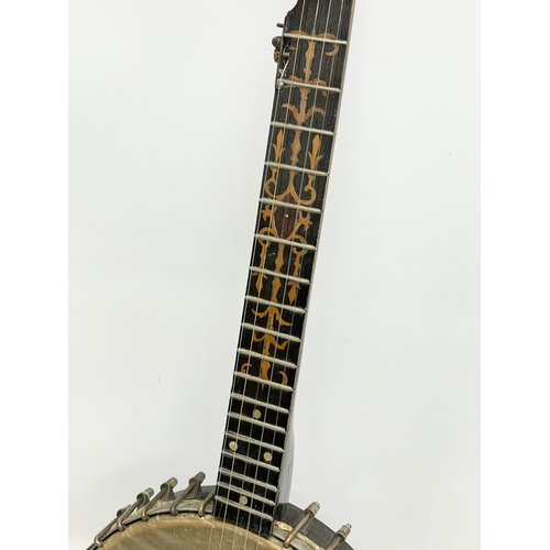 366 - A vintage banjo with case. Banjo measures 89cm