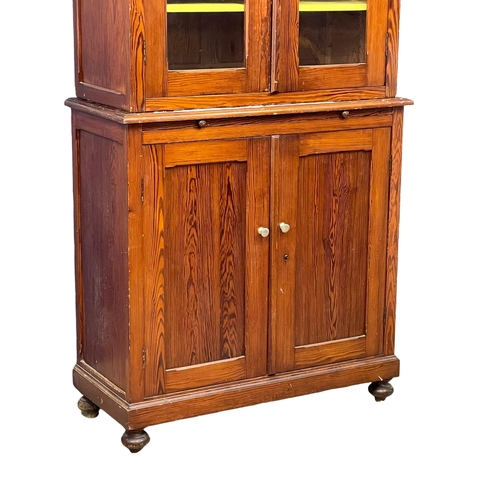 1023 - A large Victorian pitch pine kitchen dresser with brushing slide and glazed doors. 109x47x228cm (4)