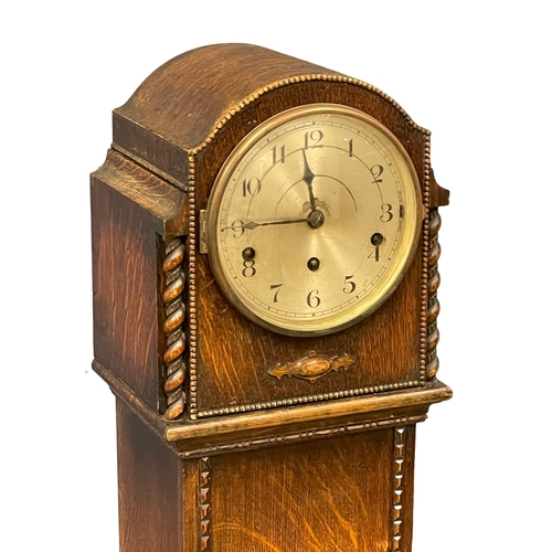 1050 - A vintage oak cased Granddaughter clock. No weights or pendulum. 133cm (9)