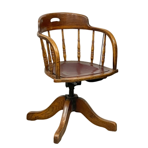 1053 - An early 20th century oak swivel desk chair by Heywood Brothers & Wakefield Co. Circa 1900. (9)