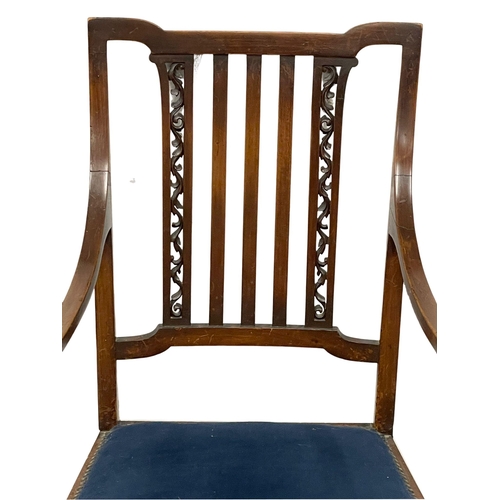 1057 - An Edwardian mahogany armchair. (8)