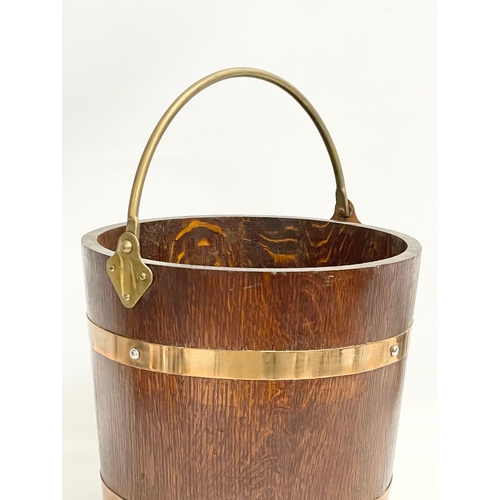 86 - An early 20th century oak brass bound coal bucket by R.A. Lister & Co LTD. Dursley, England. Circa 1... 