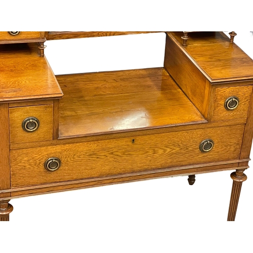 1051 - An Edwardian oak dressing table. 97x49x165cm (8)