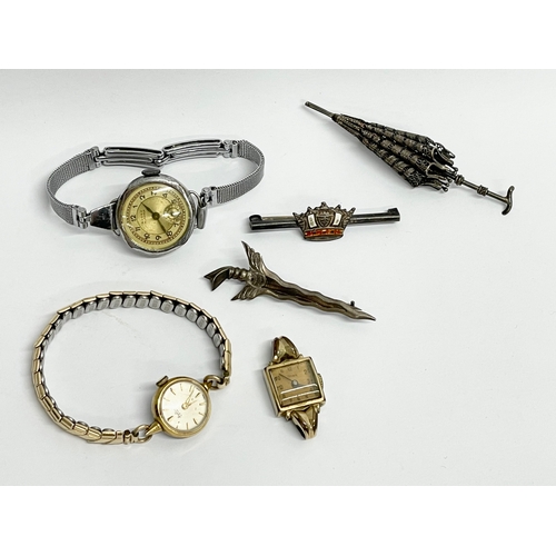 427 - A collection of vintage watches and brooches.